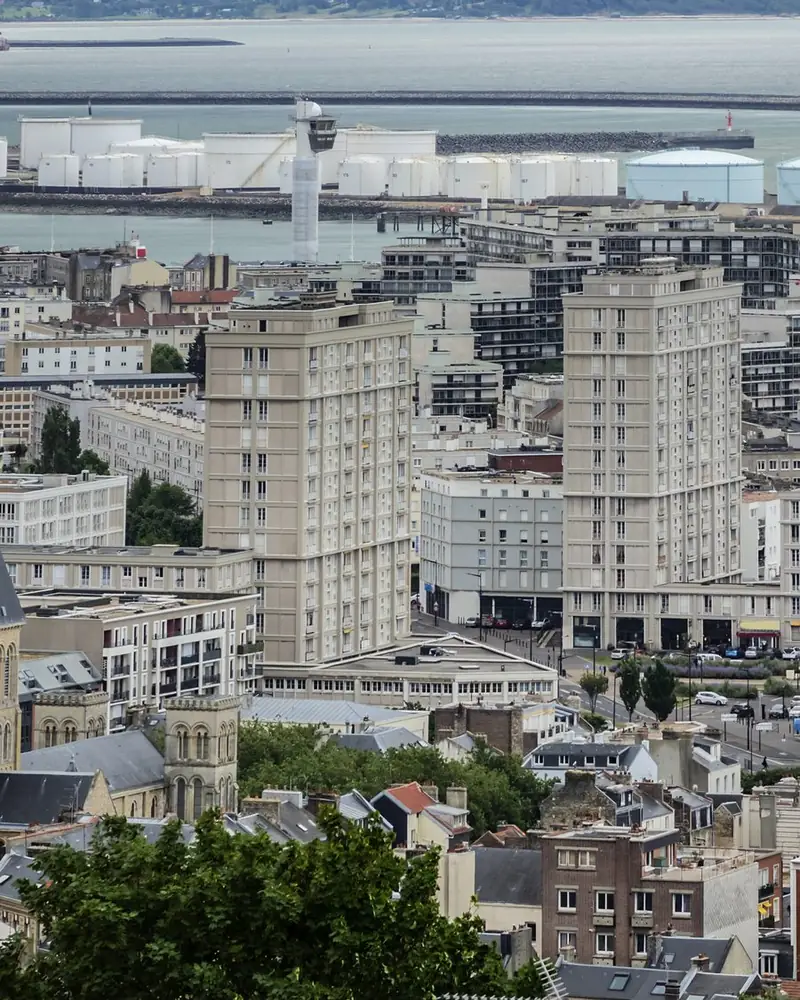 Le Havre vu des hauteurs : les tours du centre reconstruit, les réservoirs du terminal pétrolier et l'estuaire de la Seine